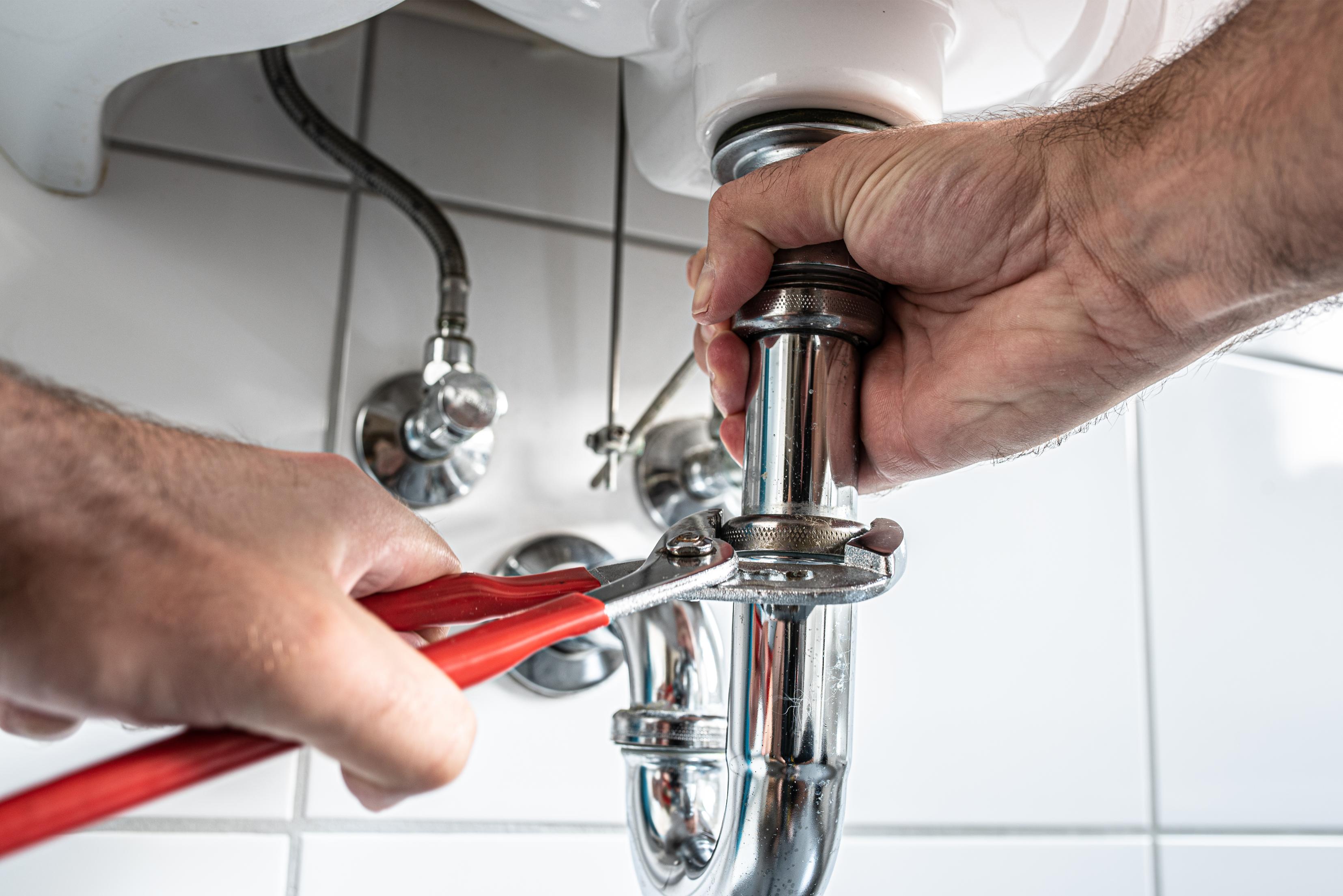 Clogged kitchen sink with standing water needing drain cleaning
