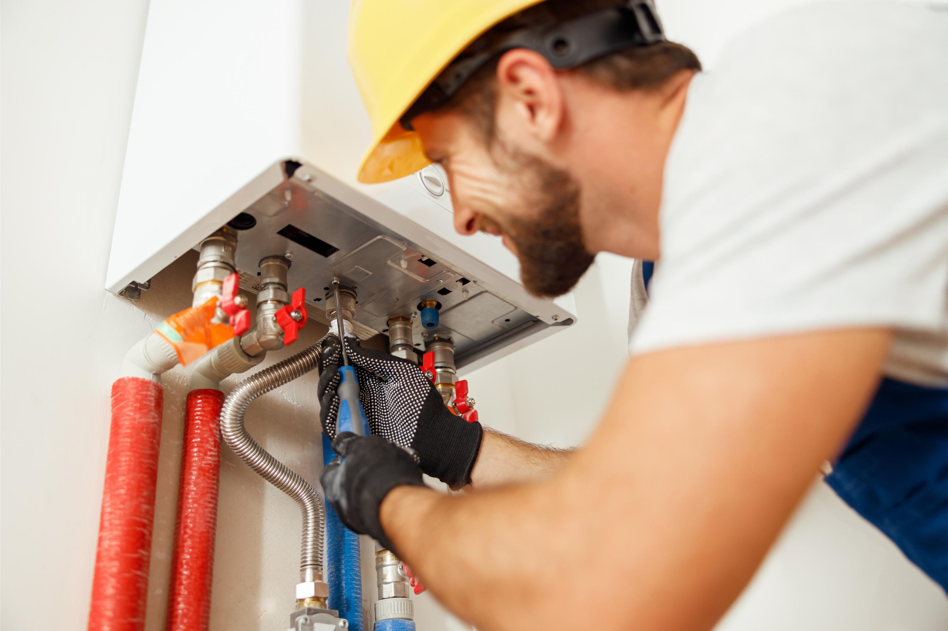 Licensed plumber installing a tankless water heater in Spring Lake, NC